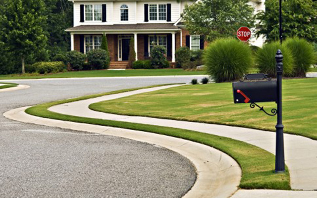 suburban cul-de-sac with white house at the end